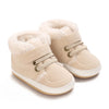 A pair of beige faux fur baby winter snow boots for toddlers.