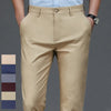 Light beige men's stretch straight-leg trousers with a tan shirt and wristwatch