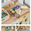 A wooden pretend play food cutting set with various colored and shaped food pieces and a knife on a wooden board.