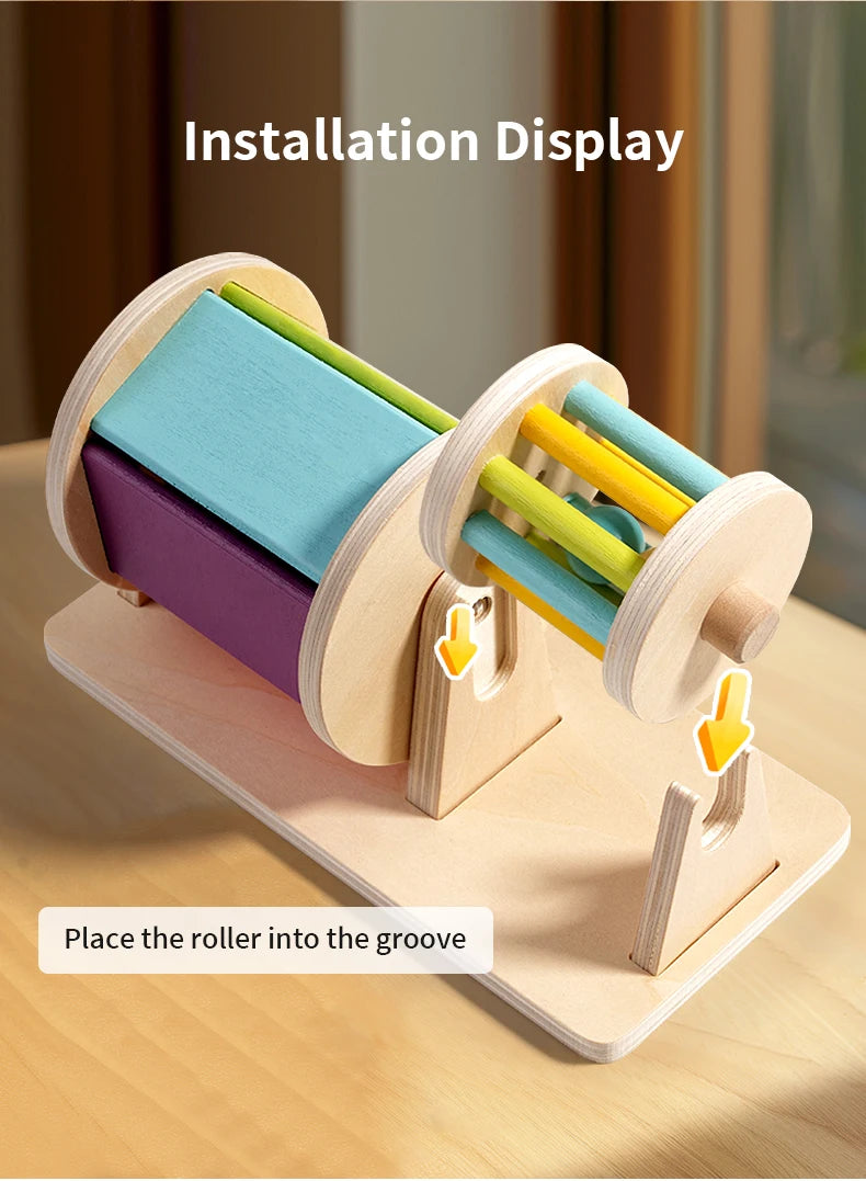 Montessori wooden spinning drum showing colorful wooden rollers placed in a groove for installation display
