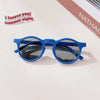 A pair of blue sunglasses with dark lenses resting on a white surface.