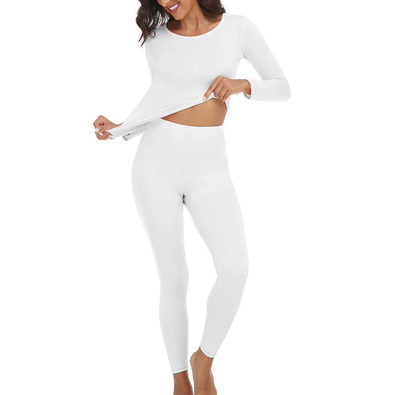 A woman models a white long-sleeved thermal top and matching leggings.