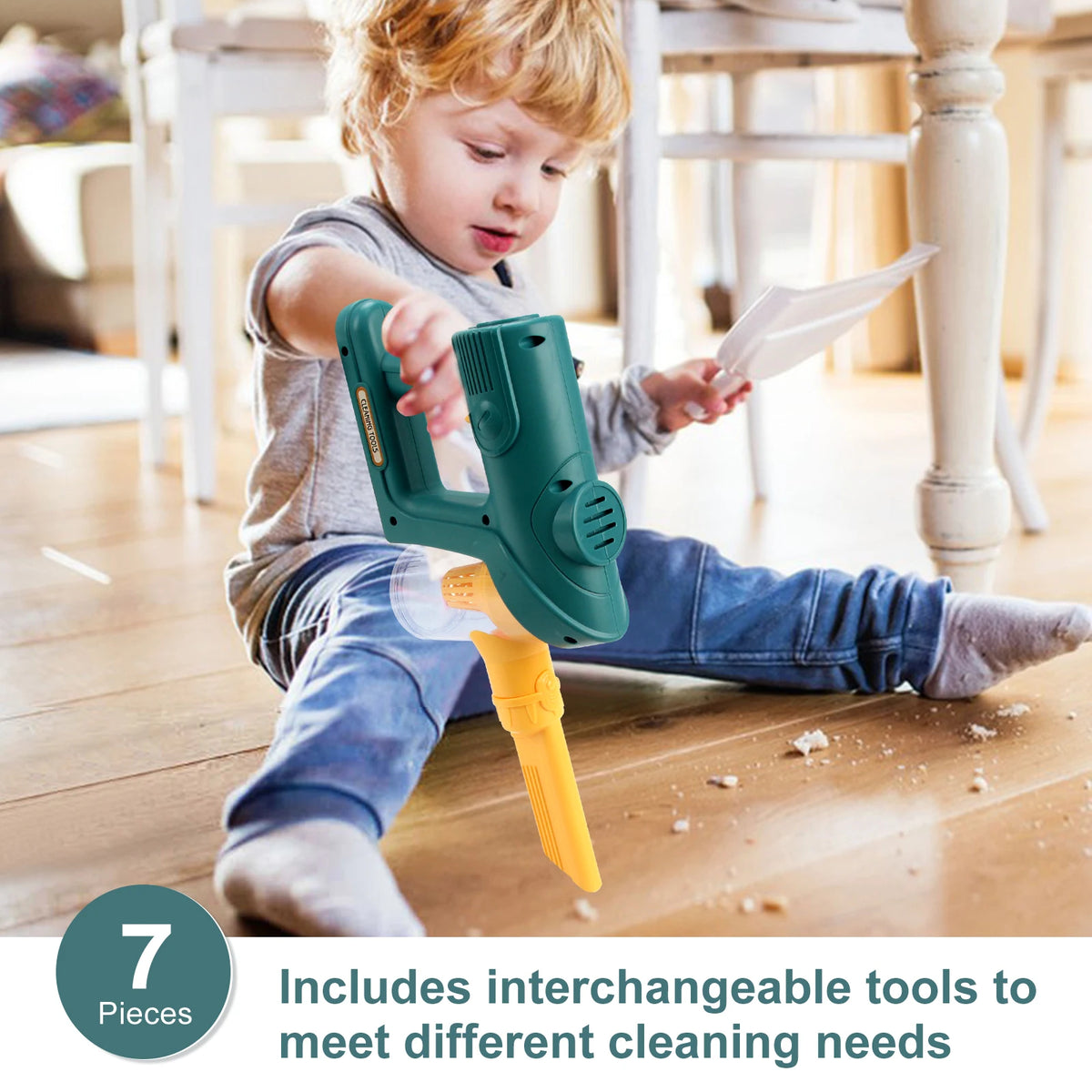 A young child is using a green toy vacuum cleaner with an orange attachment on a wooden floor.