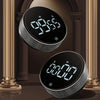 A close-up of a black magnetic kitchen timer with a silver rotary dial displaying 09:55 and 00:00.