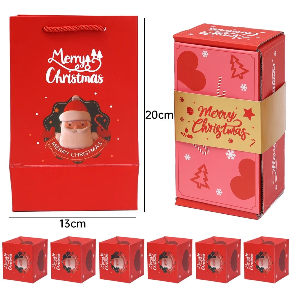 Ein Set mit roten und rosa Pop-Up-Geschenkboxen mit Weihnachtsmotiven wie dem Weihnachtsmann und Bäumen.