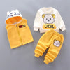 A yellow and white cartoon loungewear set for kids, including a zip-up jacket, pants, and a matching hood.