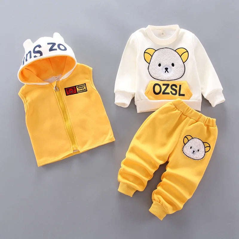 A yellow and white cartoon loungewear set for kids, including a zip-up jacket, pants, and a matching hood.