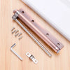 A stainless steel automatic door closer with an invisible spring mechanism and mounting hardware shown on a wooden surface.