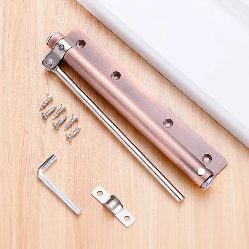 A stainless steel automatic door closer with an invisible spring mechanism and mounting hardware shown on a wooden surface.