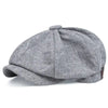 A grey vintage retro newsboy cap with a folded brim shown from above.