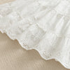 White cotton dress with delicate eyelet lace trim and ruffled tiers for a toddler girl