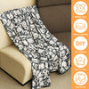 A black and white patterned blanket draped over a sofa, with icons indicating it is widely used, velvet material, DIY creatio