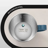 A silver stainless steel insulated travel mug with a blue handle and temperature markings is shown.