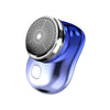 A close-up view of a blue electric shaver with a mesh head and a charging port.