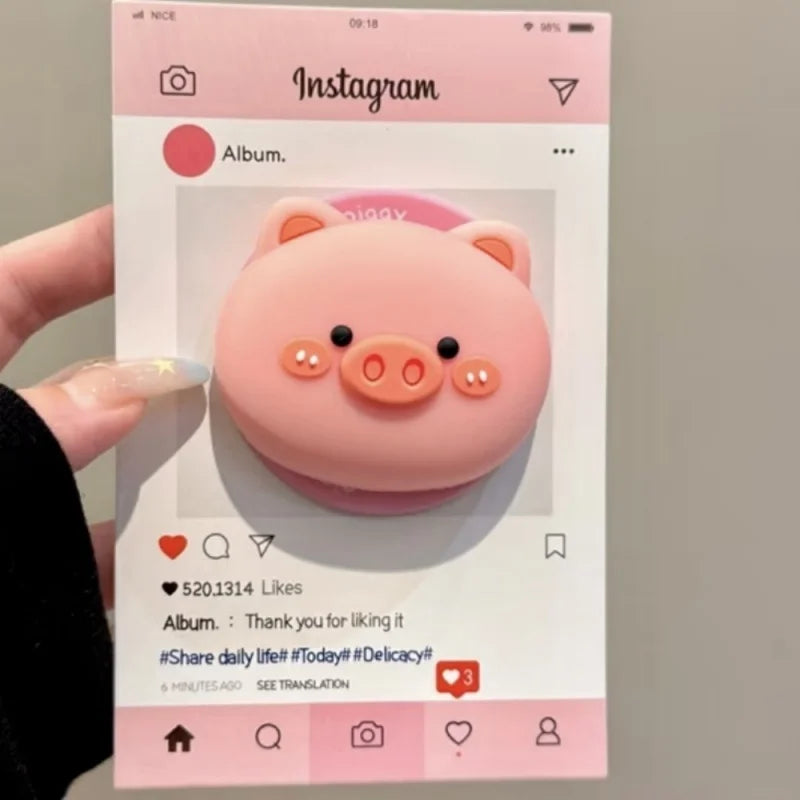 Grip magnético rosa para teléfono con forma de cerdito 3D, mostrado en una historia de Instagram.