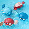 Several cute bath toys shaped like ducks and penguins float in clear blue water.