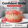 A pink complete denture is displayed on a white surface with accompanying care items and storage box.