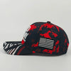 A black baseball cap featuring a red and black camouflage pattern with an embroidered American flag design.