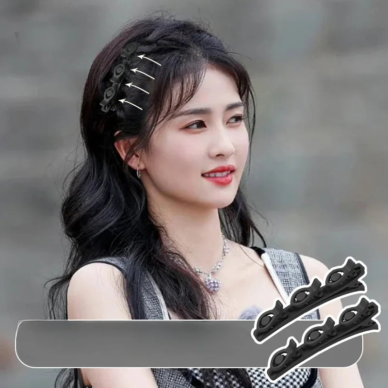 Primer plano del cabello oscuro de una mujer con ganchos trenzados dobles negros.