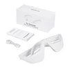 White eye massager device and accessory lying on a white box.