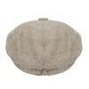 A vintage tweed flat cap with a leather label shown from above.