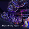 A cluster of glowing purple and blue LED light-up balloons suspended from the ceiling in a dark venue.