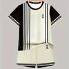 A black and white colorblock short sleeve t-shirt and matching shorts set displayed on a hanger.