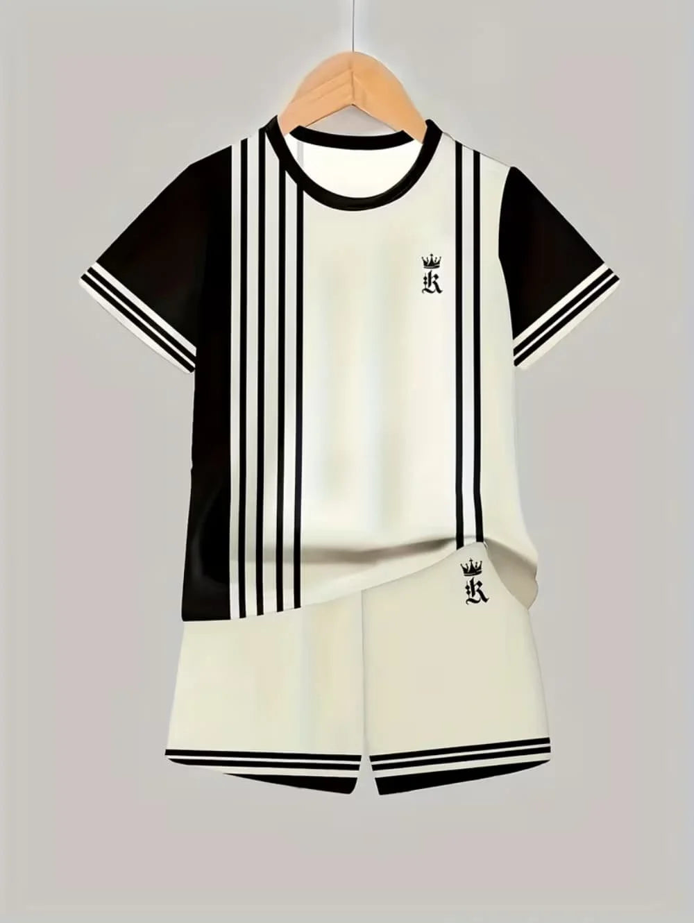 A black and white colorblock short sleeve t-shirt and matching shorts set displayed on a hanger.