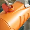 An orange water inlet pipe is shown with water flowing out, part of a dinosaur and animal sprinkler toy.