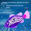 A purple robotic clownfish toy swimming underwater with white markings.