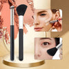 A set of professional makeup brushes including a foundation brush, powder brush, and blending brush shown in close-up detail.