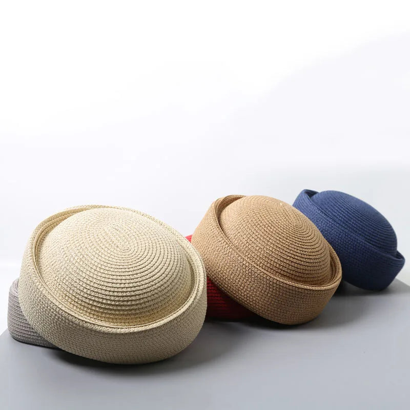 A beige straw pillbox sun hat is shown next to a blue knitted hat.