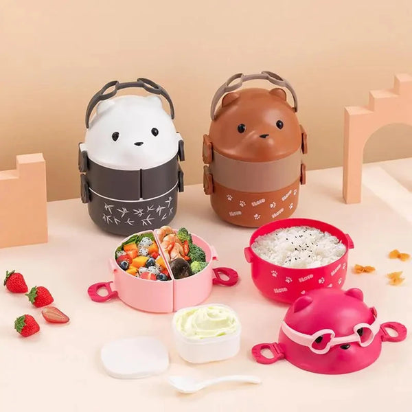 A set of stackable kids bento boxes featuring a white, brown, and pink design with silicone lids and small utensils.