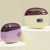 A pair of purple and beige rechargeable electric nail clippers and grinders displayed on white pedestals.