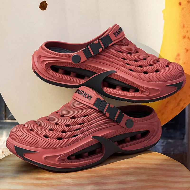 A pair of pink men's EVA slip-on sandals with cushioned platform soles resting on a wooden surface.
