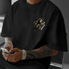 A man wearing a black Tiger Claw graphic cotton t-shirt with a black tiger claw design on the chest.