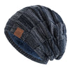 A dark gray and black knit beanie with a textured, slouchy pattern.