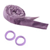 A purple heatless curling rod headband rolled into a spiral, with two separate purple silicone rings visible.