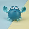 A blue bath toy shaped like a cute duck or penguin with large eyes and flippers