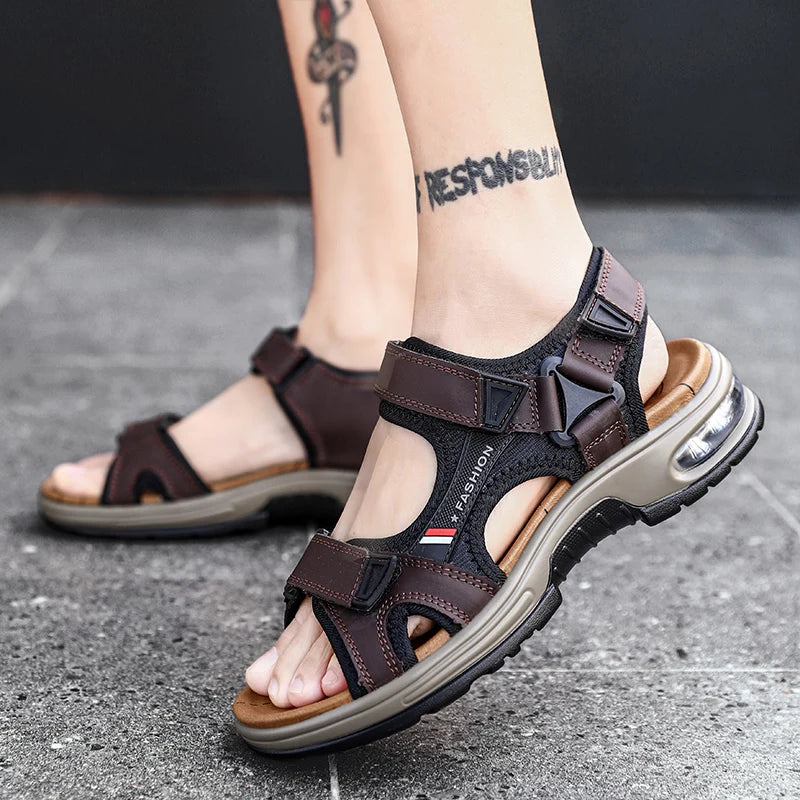 A close-up of a brown leather air cushion sandal worn on a foot, featuring black straps and a gold sole.