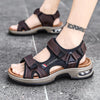 A pair of brown genuine leather air cushion sandals worn on a person's foot.