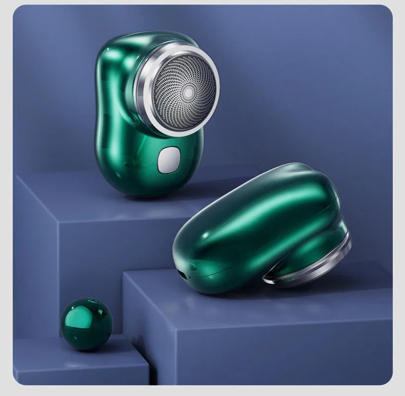 A green portable electric shaver with a silver grille is shown on a purple surface.