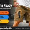 A close-up of olive green cargo shorts being worn by a man, highlighting the secure zipper pocket and features for daily comm