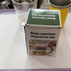 A box of a multi-function measuring cup is displayed on a white surface next to a glass and a yellow container.