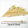 A bundle of elegant gold pearl bamboo skewers for appetizers and desserts
