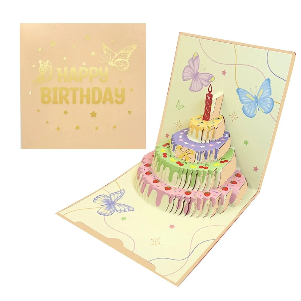 A colorful 3D pop-up birthday cake card featuring a tiered cake decorated with flowers and butterflies.