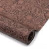 Roll of vintage floral textured faux leather fabric in brown tones