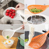 Orange kitchen strainer spoon pouring liquid into a metal bowl and a white perforated spoon with noodles