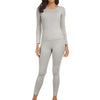 A woman wearing a long-sleeved thermal top and matching leggings in light gray.