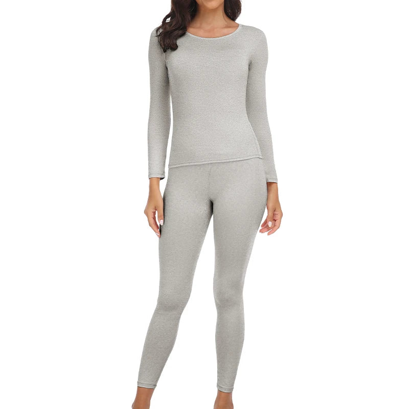 A woman wearing a long-sleeved thermal top and matching leggings in light gray.